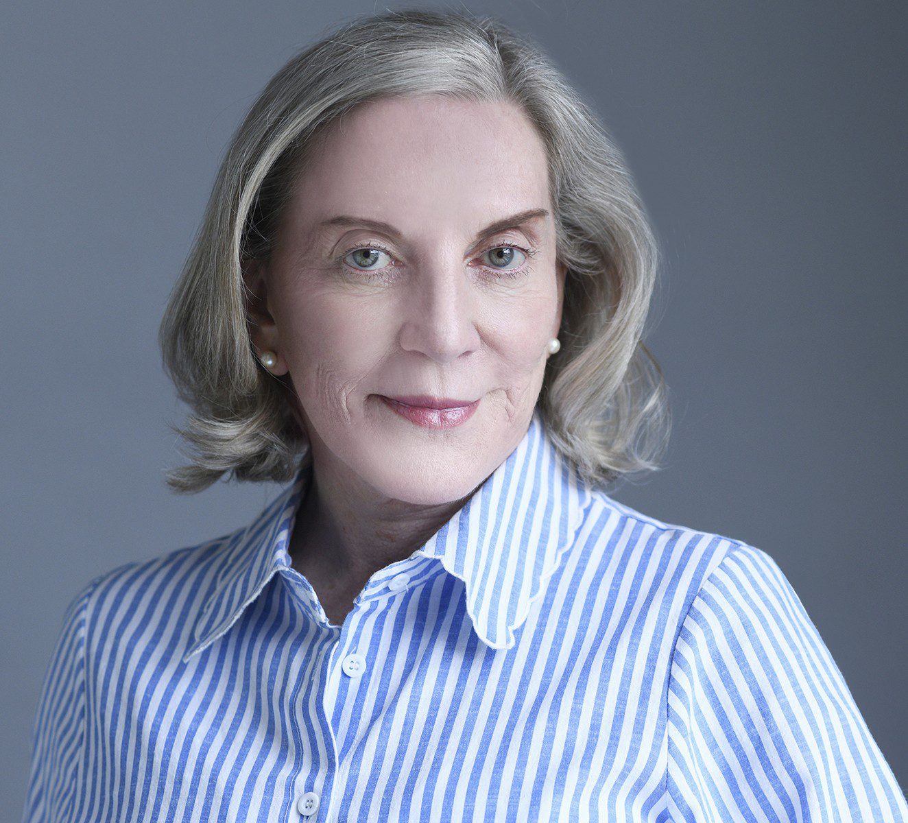 Portrait of smiling older woman in striped shirt